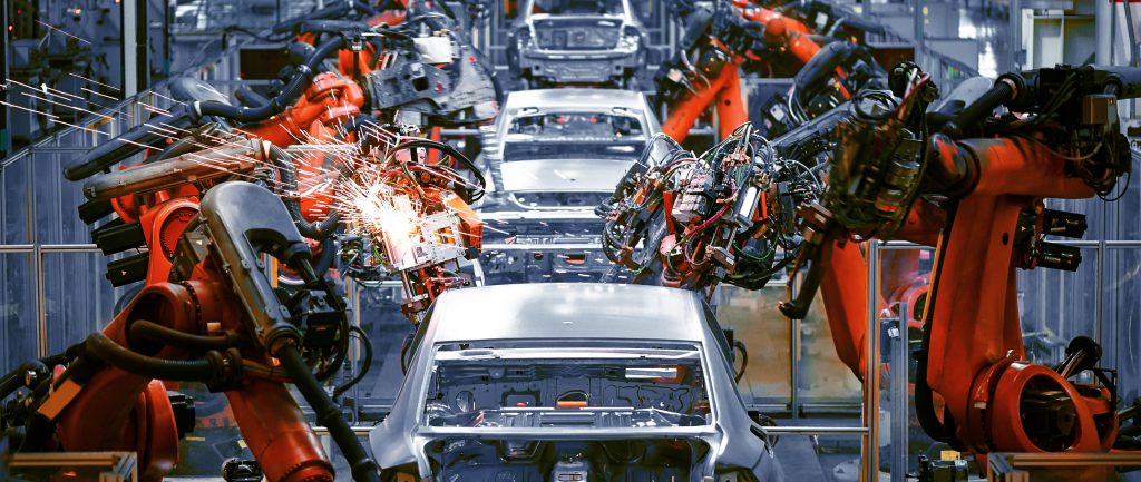 Automotive assembly line robots manufacturing a car